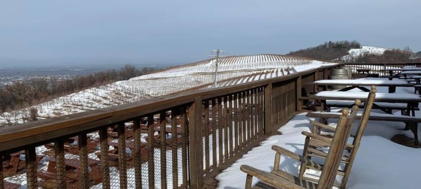 Snow covering the deck and rocking chairs at Carter Mountain Orchard