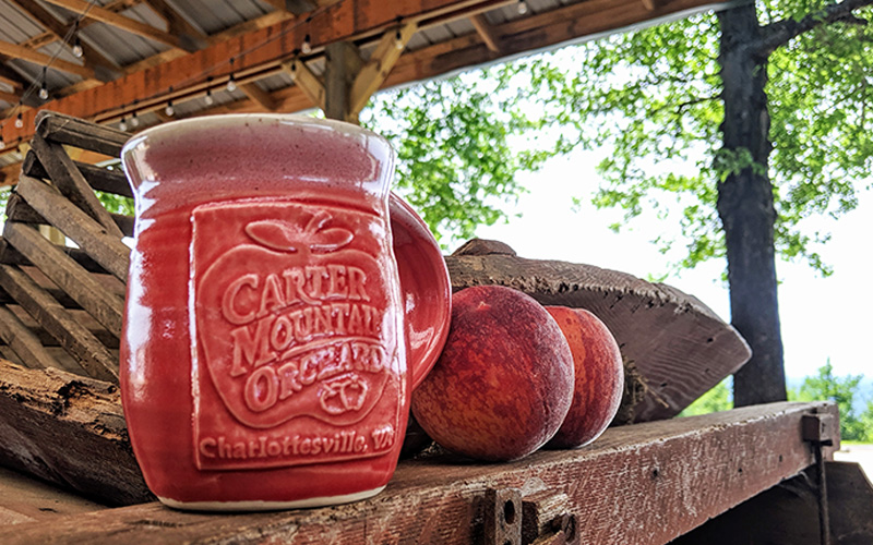 Carter Mountain Orchard handmade ceramic mug and fresh peaches